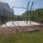 Zestaw street workout PSSX12 Medium składający się z zmodyfikowanej drabinki poziomej 3m na podpórkach po środku zamiast 2m, drążek zygzak, drabinka pionowa ze skośną i mocowaniem kółek gimnastycznych, poręczy do dipów, drążka do podciągania i uchwytu do flagi. Wszystko mocowane od betonu i później przykryte płytami SBR